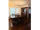 Formal dining room with wood furniture, bay windows, and a hutch at 983 Bucksaw Pl, Longwood, FL 32750