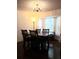 Traditional dining room featuring a dark wood table, chairs, and chandelier lighting at 983 Bucksaw Pl, Longwood, FL 32750