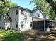 Back of house featuring screened-in porch and siding at 983 Bucksaw Pl, Longwood, FL 32750