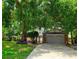 Charming two-story home with a brick garage and mature landscaping in a serene, tree-filled neighborhood at 983 Bucksaw Pl, Longwood, FL 32750