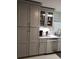Modern kitchen featuring gray cabinetry, stainless steel dishwasher, under cabinet lighting, and mosaic tile backsplash at 983 Bucksaw Pl, Longwood, FL 32750