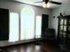 Sitting room features sleek dark wood flooring, sheer white curtains, and recessed lighting at 983 Bucksaw Pl, Longwood, FL 32750