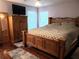 Spacious main bedroom with wooden furniture, tv, and natural light at 983 Bucksaw Pl, Longwood, FL 32750