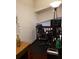 Office features a large black desk and rolling chair adjacent to a peacock feather in a vintage bottle at 983 Bucksaw Pl, Longwood, FL 32750