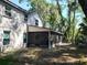View of the home's screened-in patio with a tranquil backyard and mature landscaping at 983 Bucksaw Pl, Longwood, FL 32750
