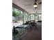 Spacious screened porch featuring brick flooring and several glass-top tables with outdoor seating at 983 Bucksaw Pl, Longwood, FL 32750