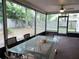 Enclosed porch with brick flooring, ceiling fan, and furniture perfect for outdoor dining at 983 Bucksaw Pl, Longwood, FL 32750