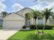 Charming single-Gathering home with a two-car garage, well-manicured lawn, and tropical palm trees at 12756 Maribou Cir, Orlando, FL 32828