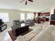 Open-concept living room with tile flooring that seamlessly connects the kitchen, dining area, and den at 12756 Maribou Cir, Orlando, FL 32828