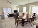 Open-concept living room and dining area with tile floors, plenty of light, and sliding doors to patio at 12756 Maribou Cir, Orlando, FL 32828
