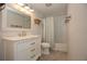 Bathroom featuring white vanity with marble countertop and white subway tile shower at 1502 E Gore St, Orlando, FL 32806