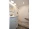 Bathroom featuring white tiled shower with a built-in seat, mosaic tiled floor, and vanity at 1502 E Gore St, Orlando, FL 32806