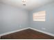 Bedroom featuring neutral paint, a window, and wood floors at 1502 E Gore St, Orlando, FL 32806