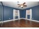 Bedroom featuring hardwood floors, two windows, and a mirrored closet at 1502 E Gore St, Orlando, FL 32806