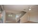Open-concept living room featuring tile floors and a staircase at 1502 E Gore St, Orlando, FL 32806