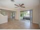 Living room with tile floors, a ceiling fan, and sliding glass doors leading to the outdoors at 1502 E Gore St, Orlando, FL 32806