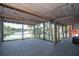 This screened sunroom boasts waterfront views, a wood ceiling, and string lights for a relaxing outdoor living space at 1502 E Gore St, Orlando, FL 32806