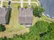 Aerial view of a house with a large yard, screened patio, and surrounding neighborhood greenery at 1551 Peterson Pl, Sanford, FL 32773