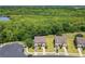 Aerial view of homes surrounded by lush greenery and a serene lake, offering a peaceful setting at 1551 Peterson Pl, Sanford, FL 32773