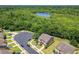 Aerial view of a home with surrounding lush greenery and a serene lake at 1551 Peterson Pl, Sanford, FL 32773