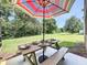 Picture of backyard with picnic table under umbrella at 1551 Peterson Pl, Sanford, FL 32773