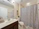 Bathroom featuring a marble countertop, framed mirror, and a stylish shower curtain with a leopard pattern at 1551 Peterson Pl, Sanford, FL 32773
