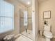 Well-lit bathroom featuring glass shower doors, tiled walls, and a decorative starfish print at 1551 Peterson Pl, Sanford, FL 32773