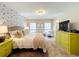 The main bedroom features bright yellow nightstands and dresser with neutral decor at 1551 Peterson Pl, Sanford, FL 32773