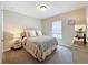 Cozy bedroom with plush carpet, neutral tones, and a comfortable bed with decorative pillows at 1551 Peterson Pl, Sanford, FL 32773