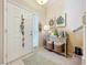Inviting foyer with tiled floor, decorative wall art, and a charming console table at 1551 Peterson Pl, Sanford, FL 32773