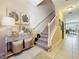 Charming home foyer featuring tiled flooring, staircase, and console table with decor at 1551 Peterson Pl, Sanford, FL 32773
