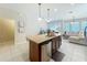 Open-concept kitchen featuring an island with granite countertop, stainless steel appliances, and ample lighting at 1551 Peterson Pl, Sanford, FL 32773