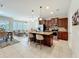 Open kitchen features an island, stainless appliances, tile floors and connects to dining and living areas at 1551 Peterson Pl, Sanford, FL 32773