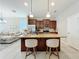 Open kitchen with a large center island, pendant lighting, and stainless steel appliances at 1551 Peterson Pl, Sanford, FL 32773