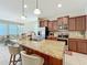 Open-concept kitchen with a center island, stainless steel appliances, and adjacent living area at 1551 Peterson Pl, Sanford, FL 32773