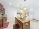 Bright kitchen featuring a center island with granite countertops and stainless steel appliances at 1551 Peterson Pl, Sanford, FL 32773