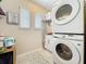 Functional laundry room with stacked washer and dryer, plus storage and natural light at 1551 Peterson Pl, Sanford, FL 32773