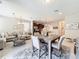Bright living room boasts an open floor plan, tile floors, a stylish chandelier, and seamlessly connects to other living spaces at 1551 Peterson Pl, Sanford, FL 32773