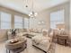 Bright living room features neutral colors, plenty of natural light, and comfortable seating at 1551 Peterson Pl, Sanford, FL 32773