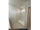 Clean bathroom featuring a walk-in shower with built-in shelving and a bright overhead light at 1575 Aspen Ave, Davenport, FL 33837