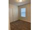 Cozy carpeted bedroom with a window and closet at 1575 Aspen Ave, Davenport, FL 33837