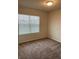 Cozy bedroom featuring plush carpeting, a window with blinds, and neutral wall, creating a relaxing space at 1575 Aspen Ave, Davenport, FL 33837