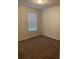 Carpeted bedroom featuring a window with blinds at 1575 Aspen Ave, Davenport, FL 33837