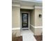 Close-up of the front door with a welcome mat at 1575 Aspen Ave, Davenport, FL 33837