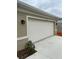 Close-up of the two-car garage with the address number above it at 1575 Aspen Ave, Davenport, FL 33837