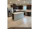 Bright kitchen featuring stainless steel appliances, dark cabinets, and a center island with light countertop at 1575 Aspen Ave, Davenport, FL 33837