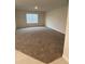 Spacious living room area featuring neutral walls and large windows, perfect for relaxation at 1575 Aspen Ave, Davenport, FL 33837