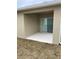 A covered patio area with a sliding glass door at 1575 Aspen Ave, Davenport, FL 33837