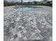 Community pool with light blue water, paved deck, zero entry, and metal fencing in a neighborhood of homes at 1575 Aspen Ave, Davenport, FL 33837