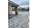 Community pool with stone accents, shower, and paved deck area, all surrounded by new homes and dark metal fencing at 1575 Aspen Ave, Davenport, FL 33837
